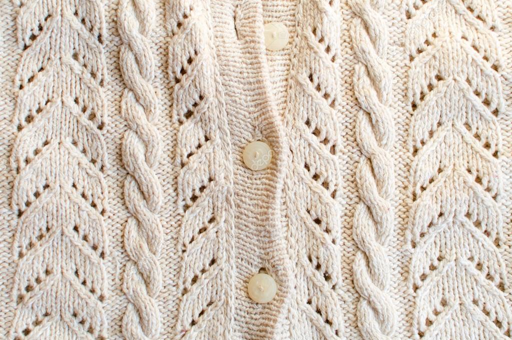 Knitted fabric with white buttons closeup