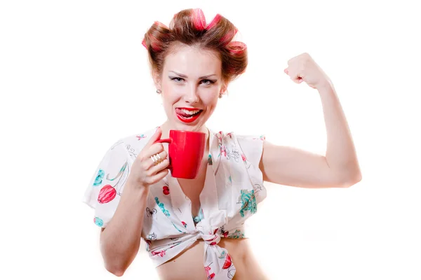 Closeup portrait on beautiful funny pinup blond young woman with red lips having fun drinking tea happy smiling looking at camera and showing biceps muscles on white background picture — Stock Photo, Image