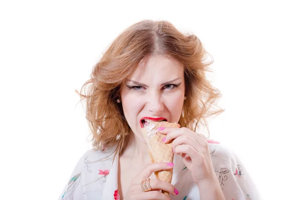 Beautiful young pinup woman eating ice cream cone looking in camera isolated on white background — Stock Photo, Image