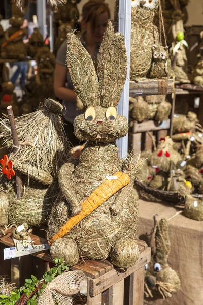 Straw rabbit with carrot sitting on a chair — Stock Photo, Image