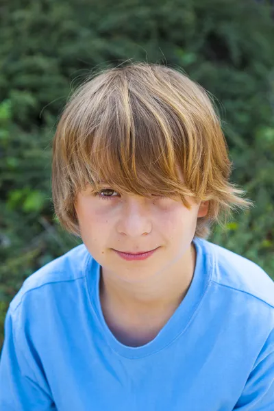 Smart boy sitting on a bench — Stock Photo, Image