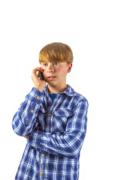 Cute handsome young boy speaking with a mobile phone — Stock Photo, Image