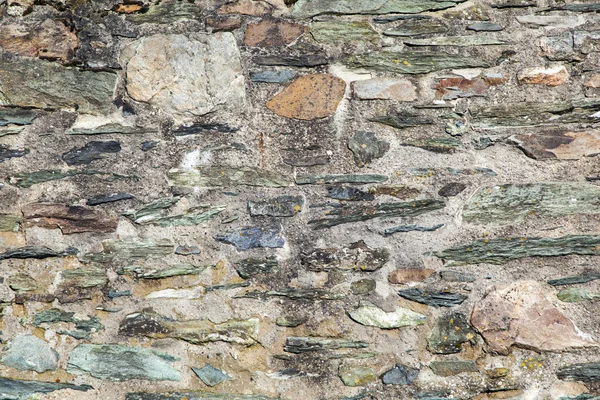 Ściana zbudowana z nieobrobionych kamieni naturalnych, w różnych rozmiarach — Zdjęcie stockowe