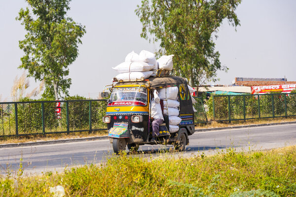 Public transport in India .Crazy road scene -truck with overload