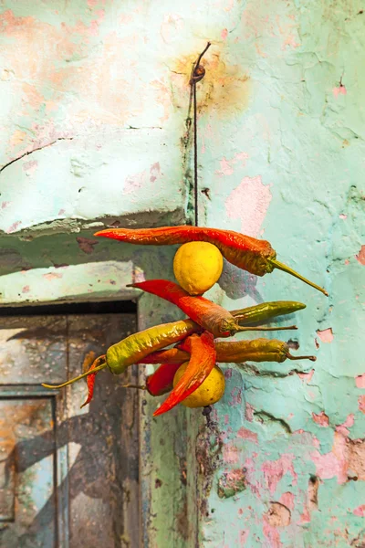 Spices hanging at the facade as a donation to godness — Stock Photo, Image