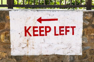 Keep left sign painted at a wall clipart