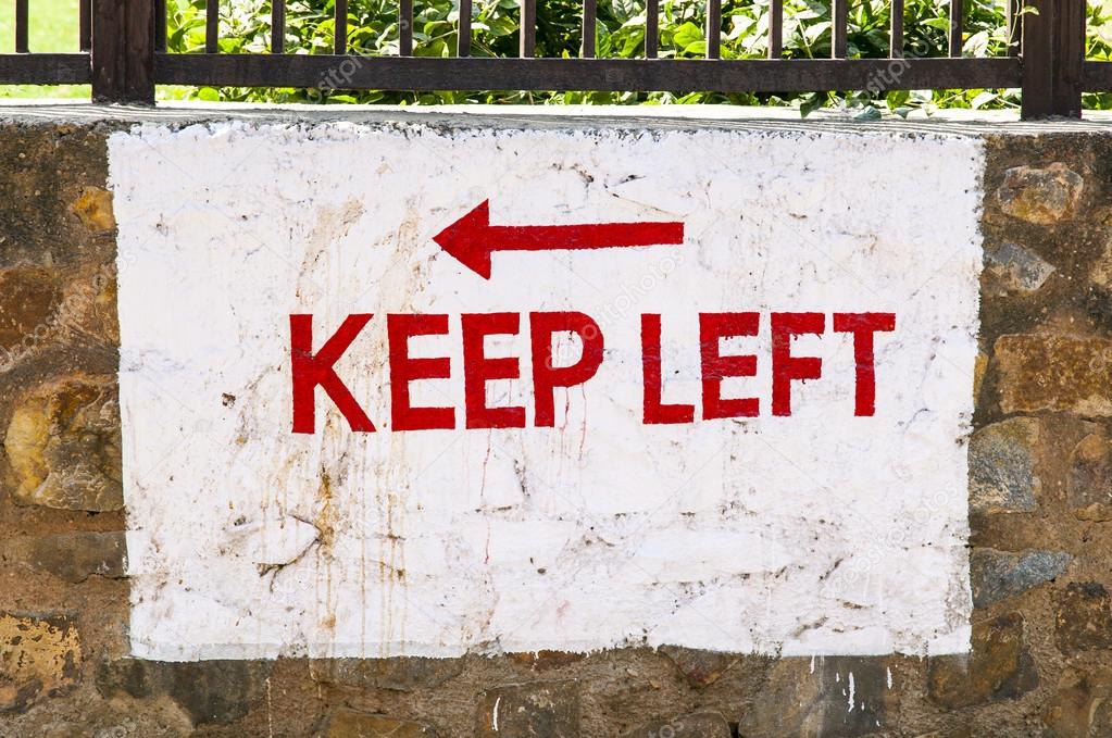 Keep left sign painted at a wall