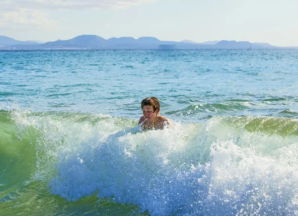 Chłopiec ma fun surfing w fale — Zdjęcie stockowe