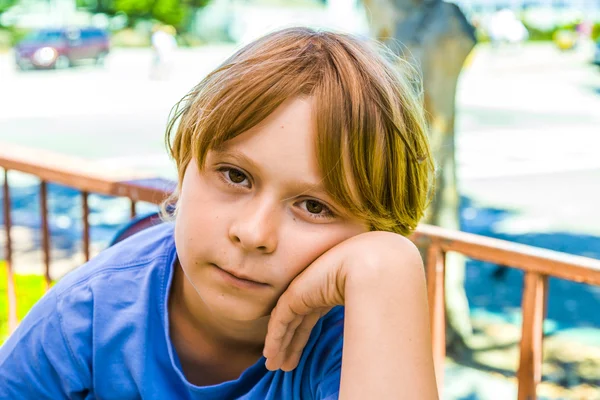 Boy with brown hair is looking displeased — Stock Photo, Image