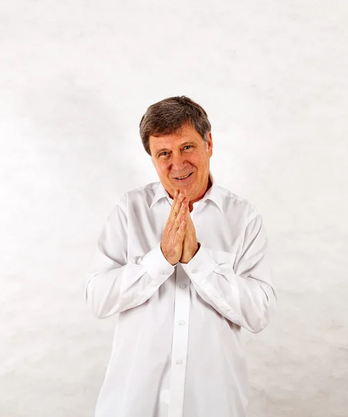 Happy senior man standing gesturing against white background — Stock Photo, Image