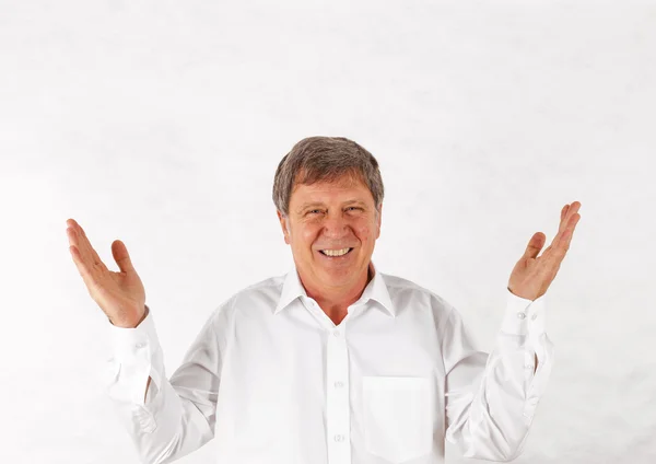 Happy senior man standing gesturing against white background — Stock Photo, Image