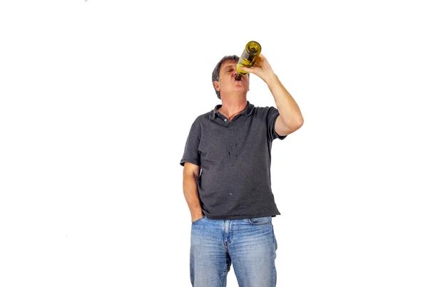 Man drinks alcohol out of a bottle — Stock Photo, Image