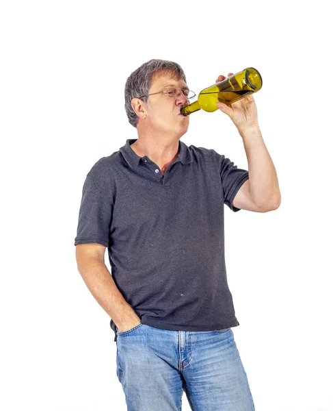 Man drinks alcohol out of a bottle — Stock Photo, Image