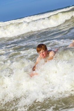 child has fun in the waves