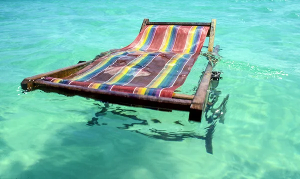 Canvas beach cjair floating in the ocean — Stock Photo, Image