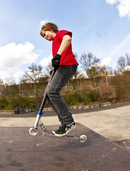 Boy going airborne with a scooter — Stock Photo, Image