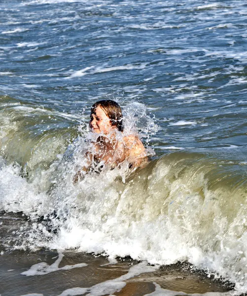 Boy enjoys the beautiful waves Stock Picture