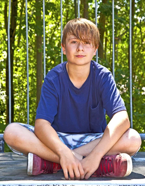 Young happy boy sweating and exhausted from sports — Stock Photo, Image