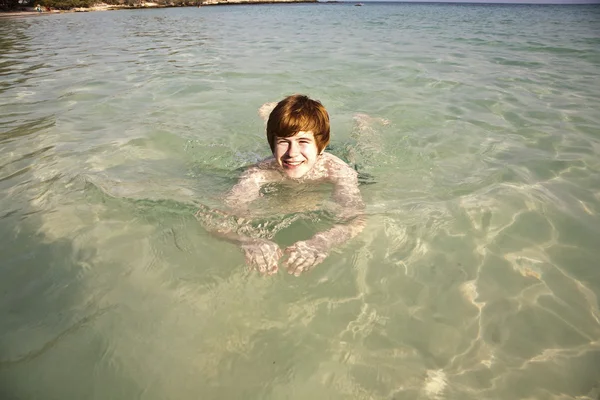 Boy swimming in the beautiful clear ocean — Stock Photo, Image