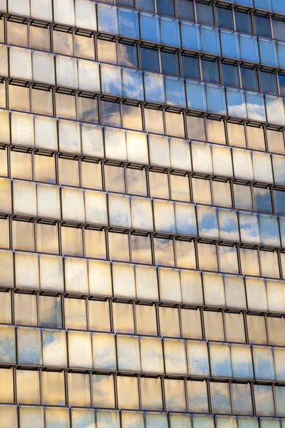 Riflessione di cielo e nubi in una facciata di un grattacielo — Foto Stock