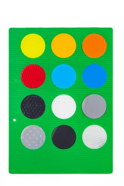 Green sheet with different colorful round color samples — Stock Photo, Image