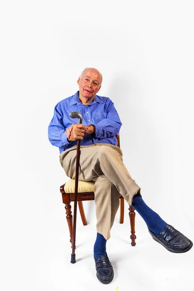 Happy elderly man sitting in a chair — Stock Photo, Image