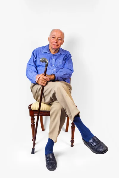 Happy elderly man sitting in a chair — Stock Photo, Image