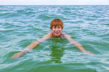 Çocuk okyanusta yüzüyor