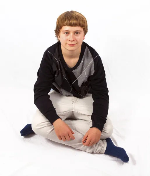 Smart happy young boy posing in studio — Stock Photo, Image