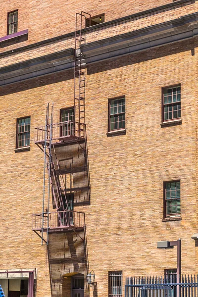 Fire ladder at an old Brick house — Stock Photo, Image