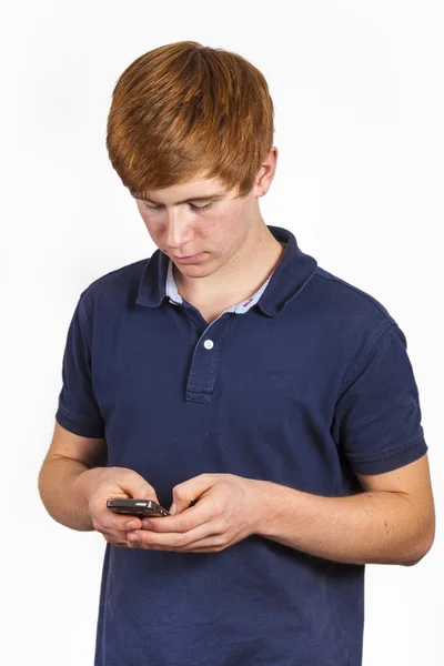 Cute handsome boy dialing with his mobile — Stock Photo, Image