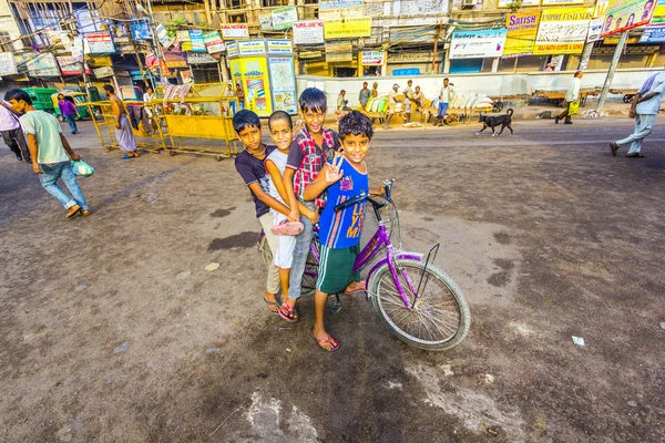 Children sitting on a bike early morning — Stock Photo, Image
