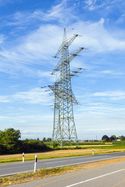 Electrical tower in landscape with street — Stock Photo, Image