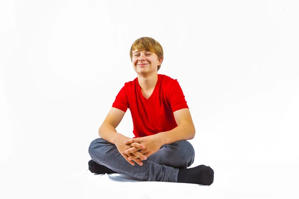 Cute boy leans on his head with his arm — Stock Photo, Image