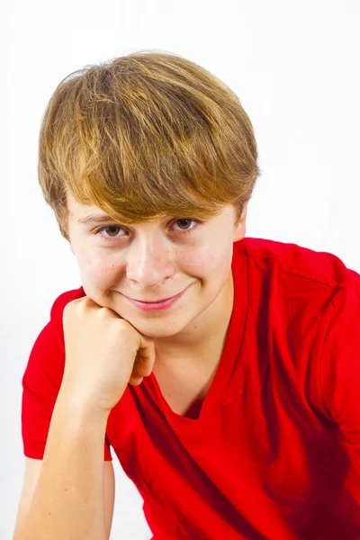 Cute boy leans on his head with his arm — Stock Photo, Image