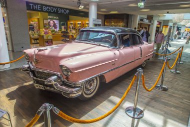 pink 1956 Cadillac at the airport clipart