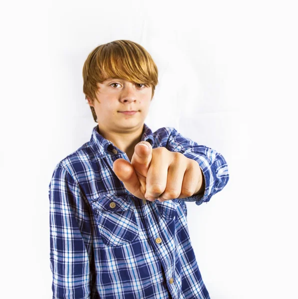 Portrait of cute young happy boy pointing to someone — Zdjęcie stockowe