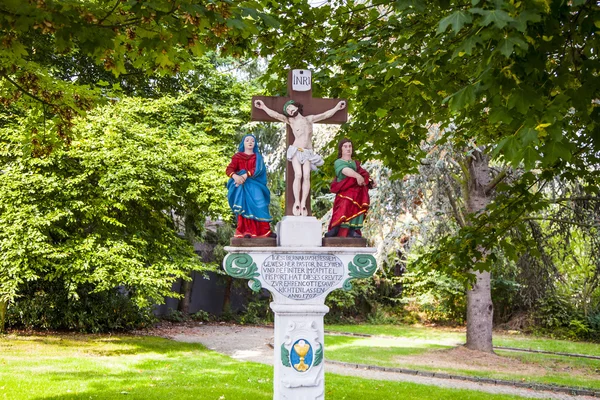 Old painted crucifix to remember a dead priest near Trittenheim, — Stock Photo, Image