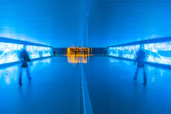 Tunnel with pedestrians in motion in blue cool light — Stock Photo, Image