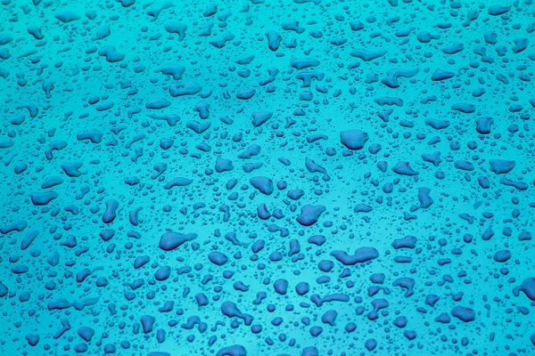 Blue pattern of raindrops at a metal surface — Stock Photo, Image