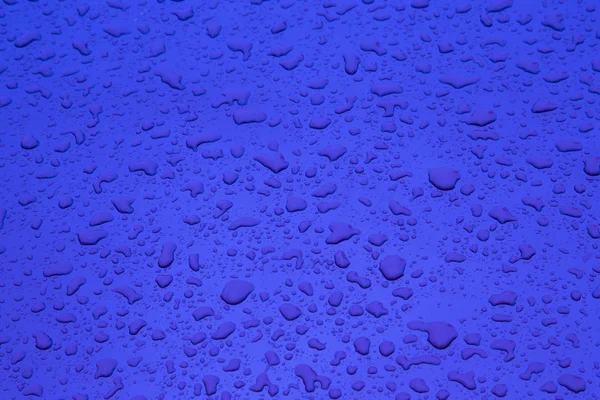 Red pattern of raindrops at a metal surface — Stock Photo, Image