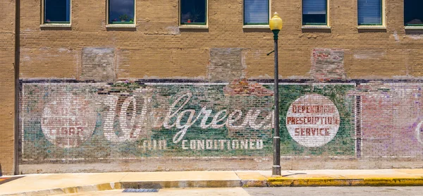 Old painted advertising at the wall — Stock Photo, Image