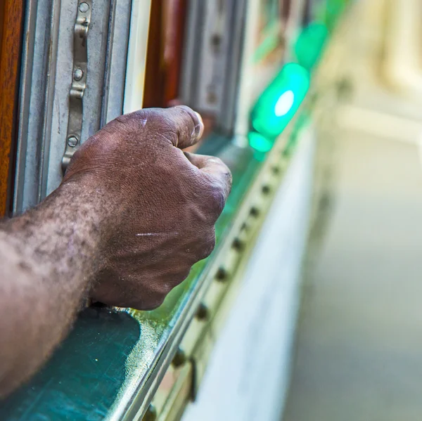 Black man leans his arm out of the streetcar — Stock Photo, Image