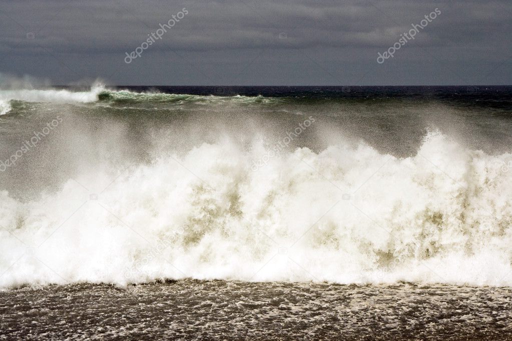heavy waves with white wave crest in storm at the beach