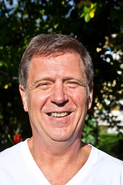 Happy attractive man in the garden — Stock Photo, Image