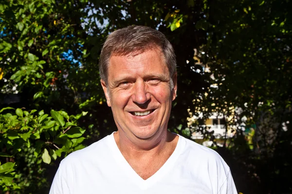 Happy attractive man in the garden — Stock Photo, Image