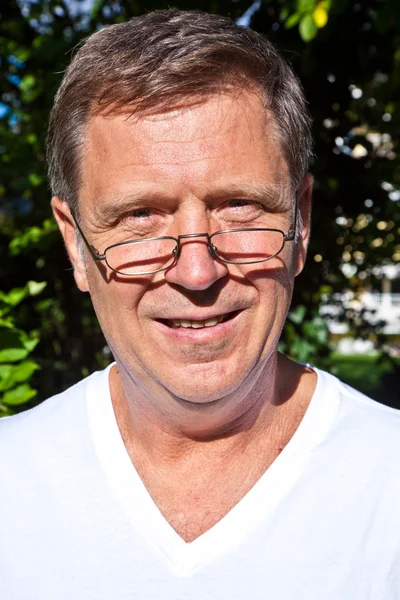 Happy attractive man in the garden — Stock Photo, Image