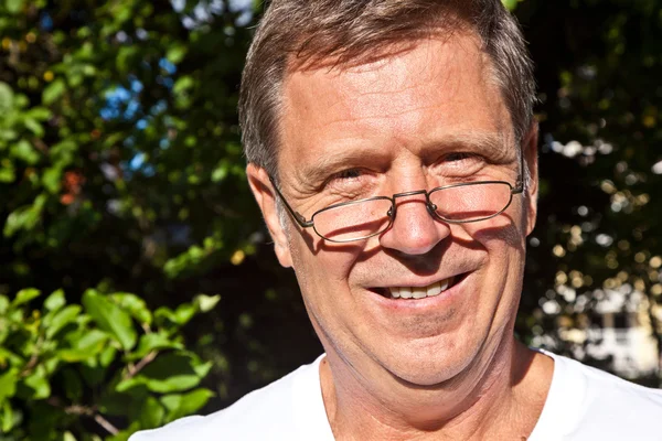 Happy attractive man in the garden — Stock Photo, Image