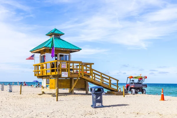 Insanlar sunny Isles cankurtaranlar içinde korunmuş plaj keyfini çıkarın. — Stok fotoğraf