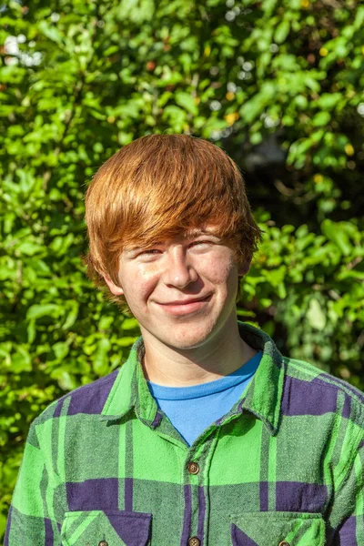 Ritratto di attraente felice ragazzo sorridente in giardino Foto Stock